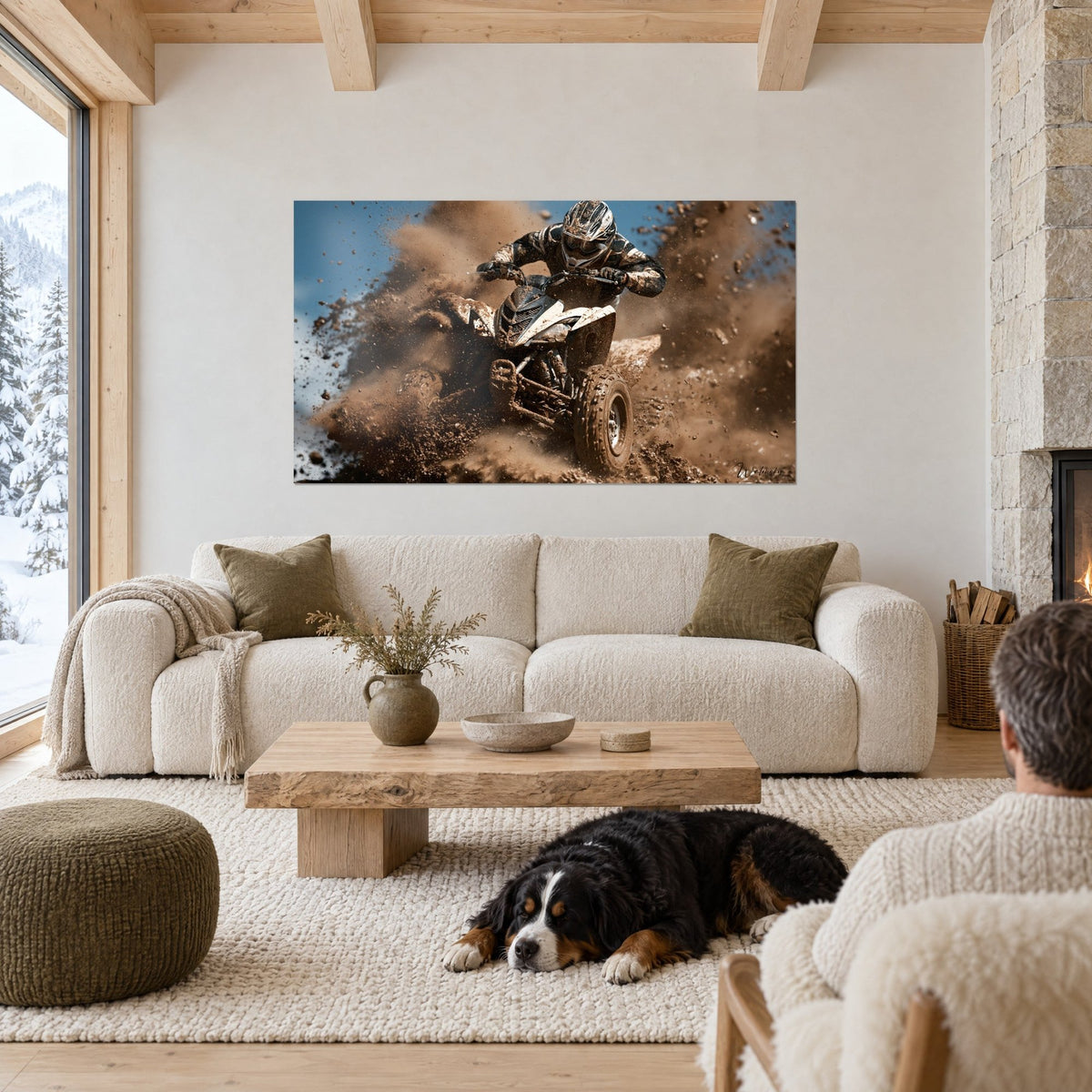 Wall art white and black quad throwing up brown clods of earth, helmeted rider, dog lying with its back turned, above a sofa in a bright living room