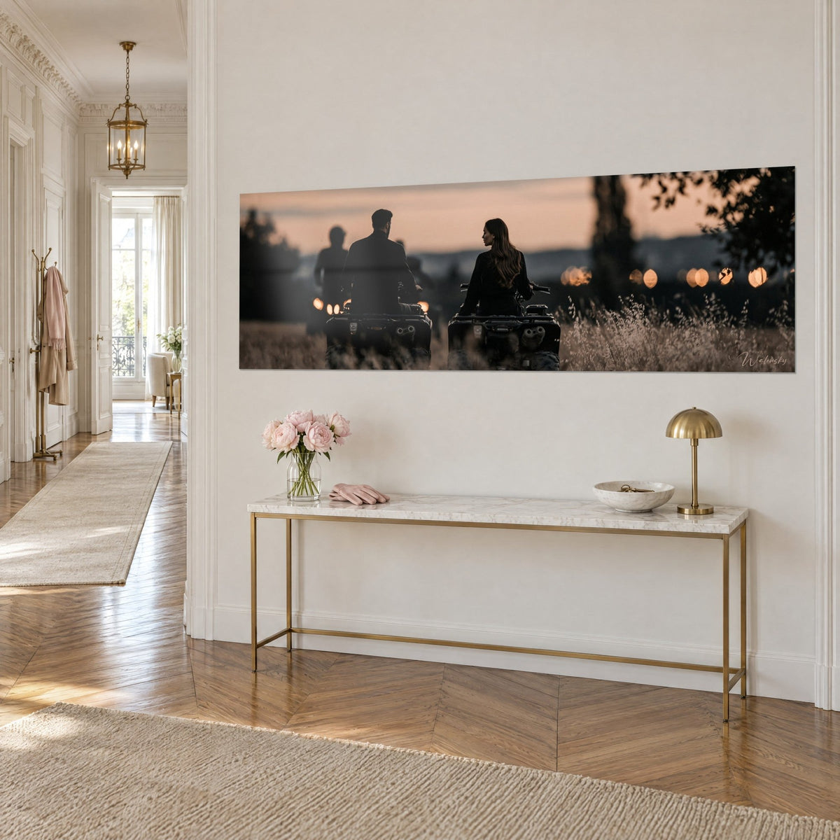 Wall art duo on quad bikes under an apricot sky, charcoal silhouettes and amber bokeh, hung on a Haussmann-style corridor wall