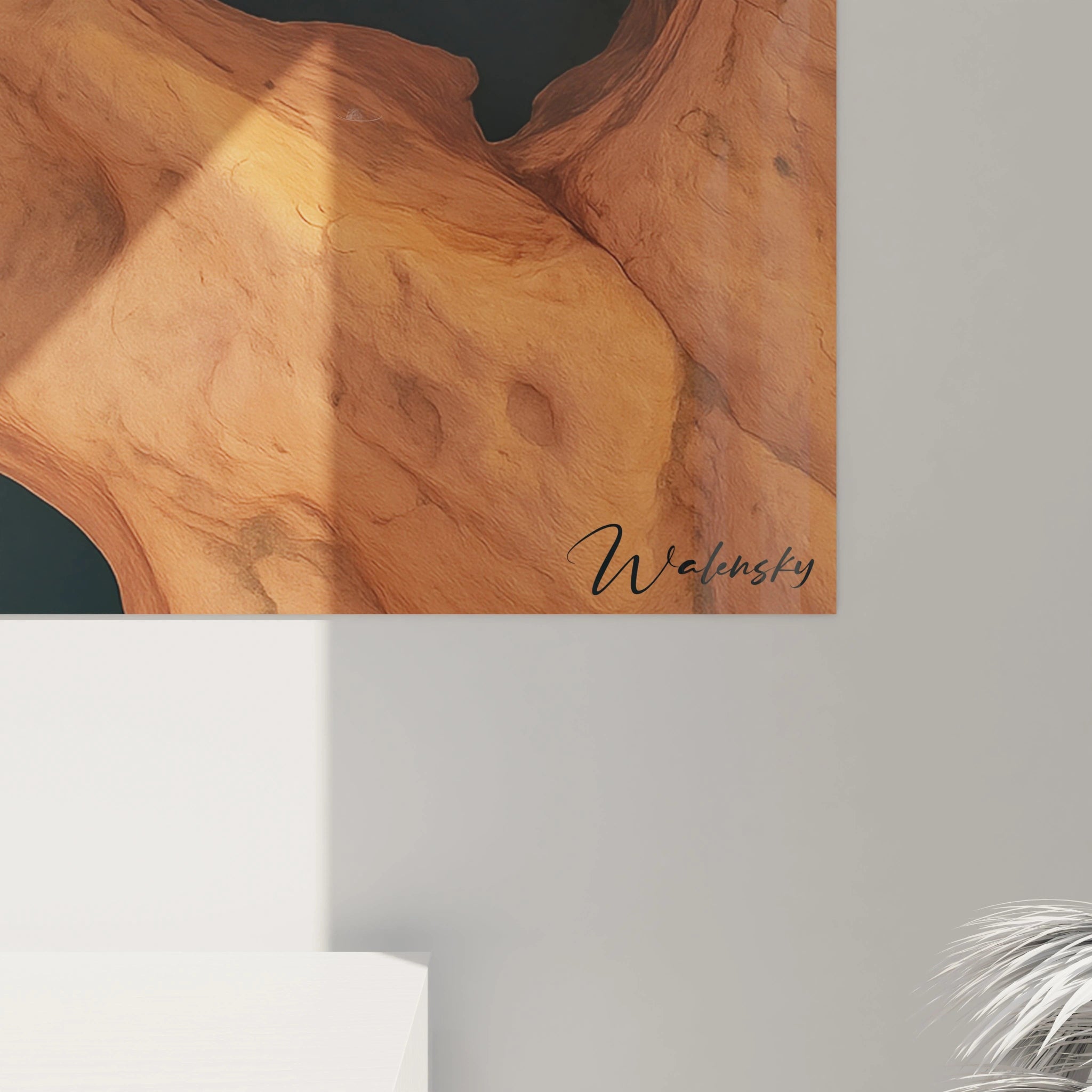 Un tableau géologique présentant une rivière sombre qui trace un chemin sinueux à travers des structures rocheuses orangées. La perspective aérienne met en évidence les reliefs naturels et les textures rugueuses du terrain désertique aux teintes chaudes.