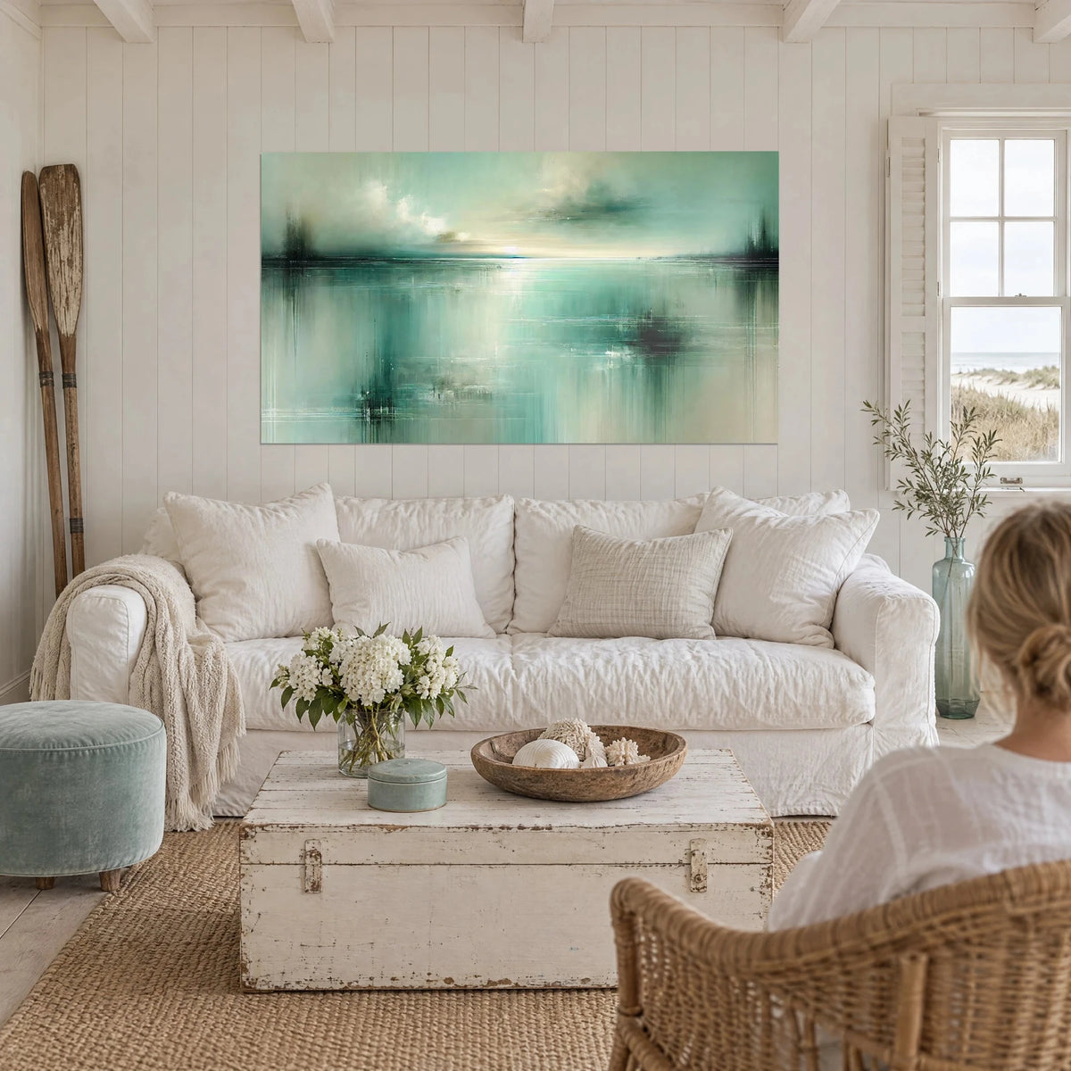 Wall art abstract jade green and cream lagoon, streaked reflections, person seen from behind, hanging above a sofa in a bright living room