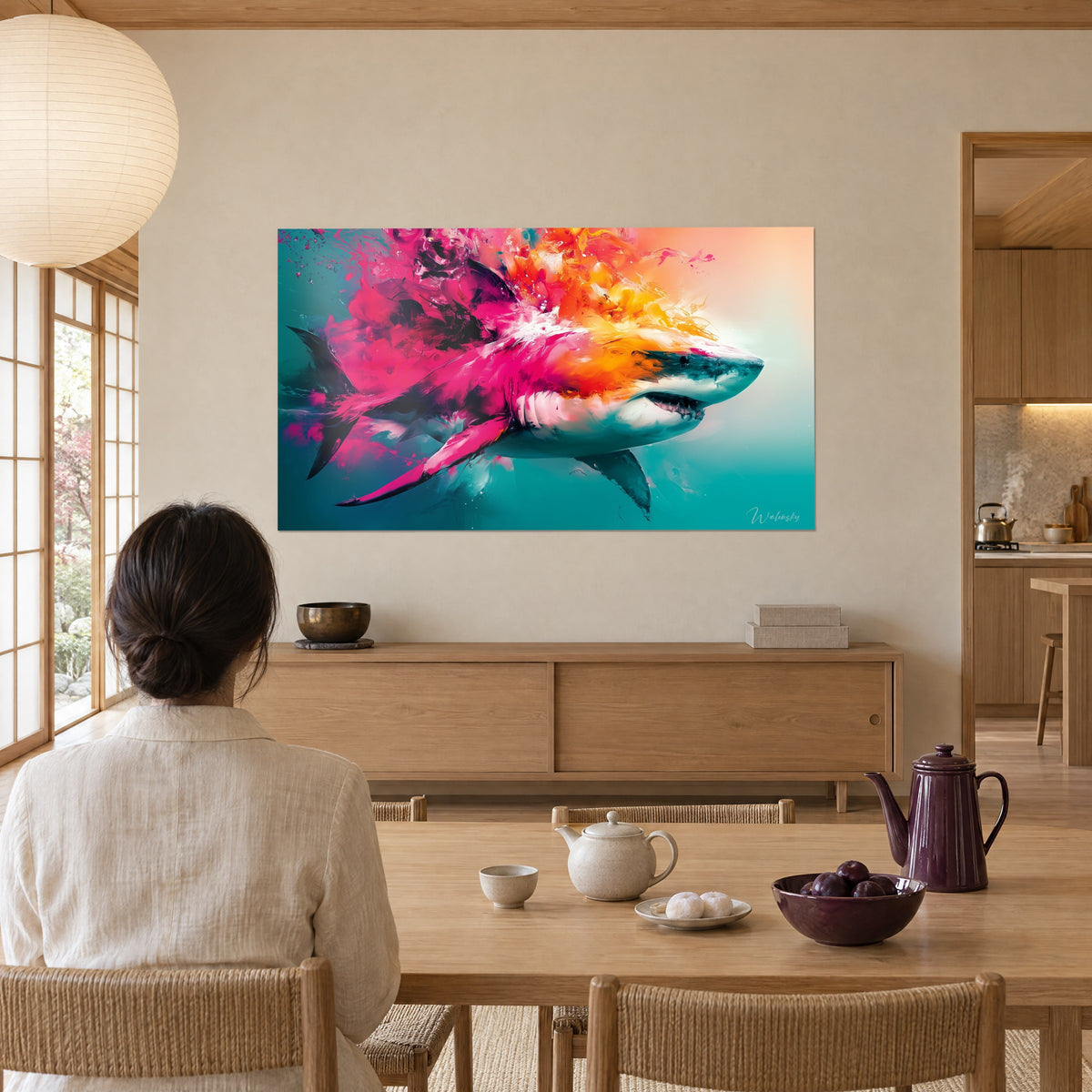 Wall art copper-toned shark made of fuchsia and tangerine pigments, white belly and green water, facing a light wood table with steaming tea
