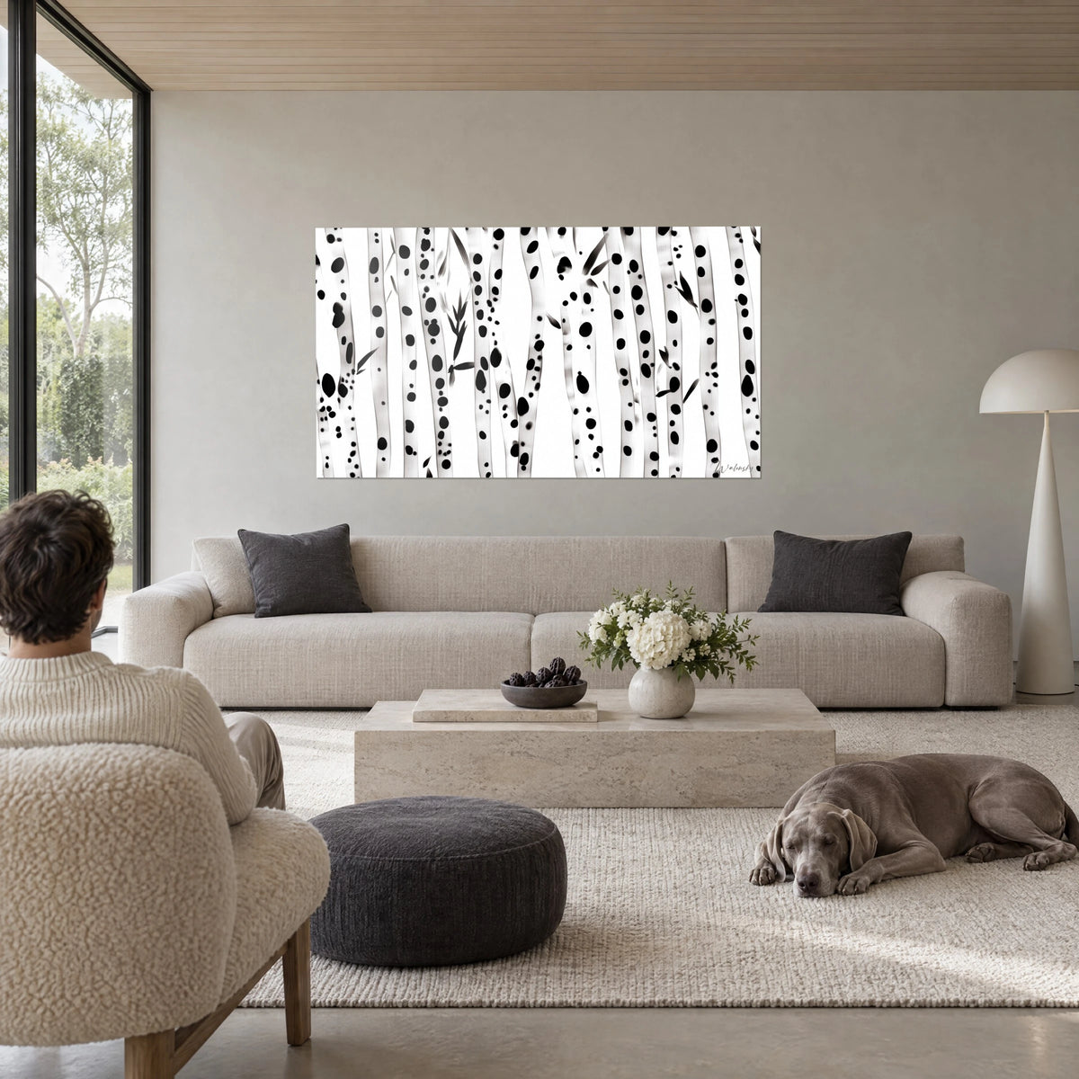 Gemälde mit Birkenstämmen, mit schwarzer Tinte getupft auf weißem Hintergrund, schmale Blätter, über einem Sofa in einem hellen Wohnzimmer