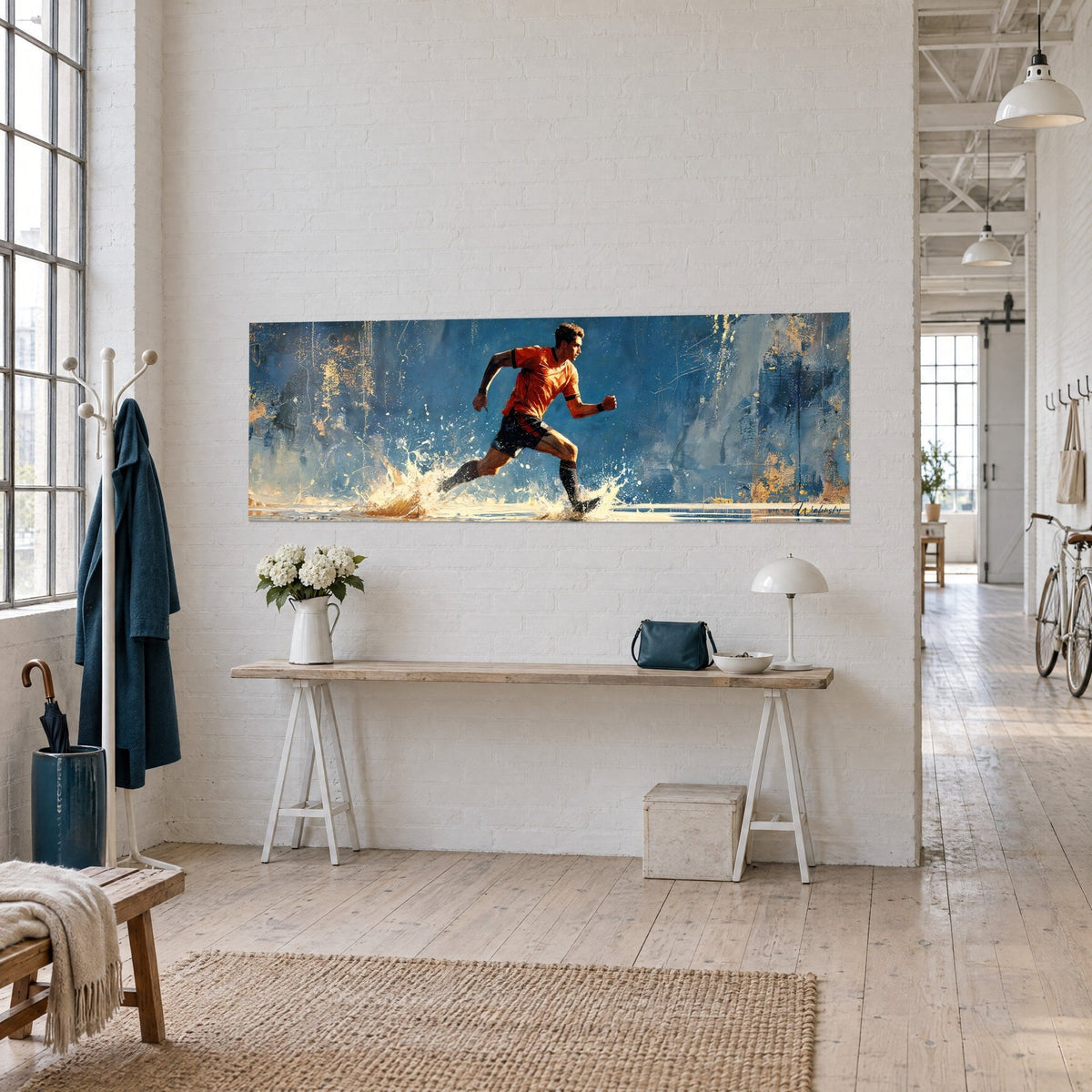 Wall art of a runner in an orange jersey and dark shorts, white spray splashing on a midnight blue background, white wooden console