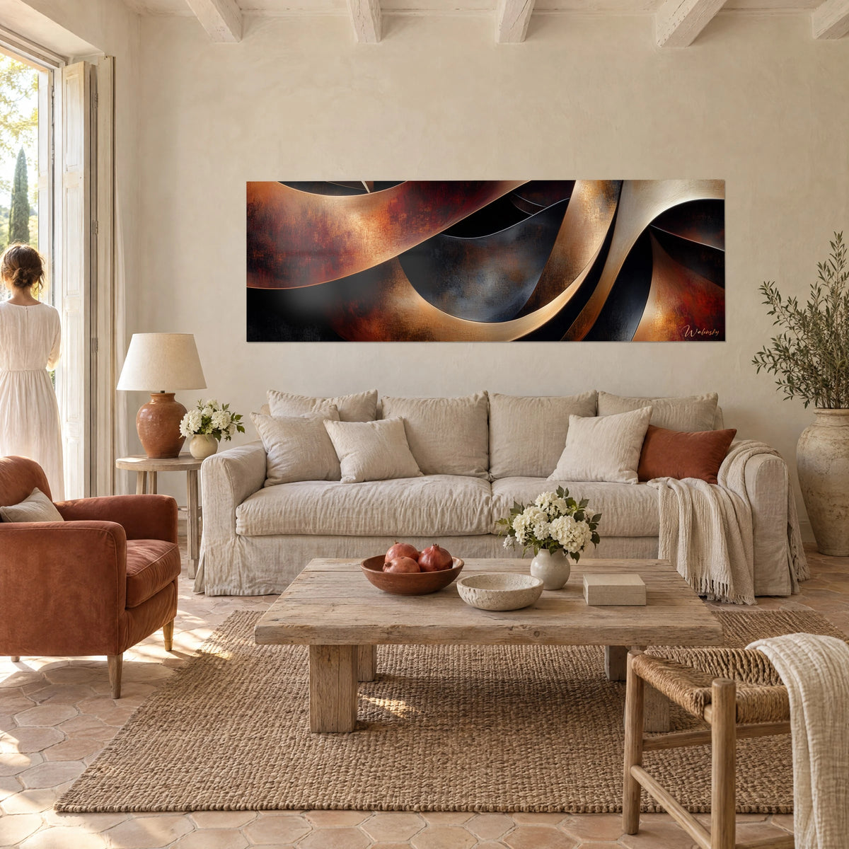 Wall art with copper ribbons undulating on a black background, rust and ochre tones; couple seen from behind, above a sofa in a bright living room