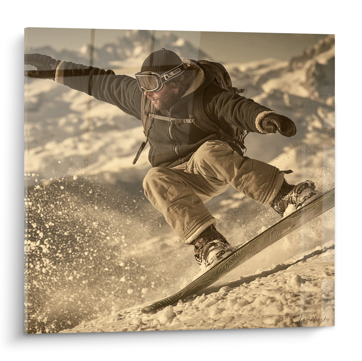 Snowboardeur en saut, veste anthracite et pantalon beige, poudreuse dorée projetée