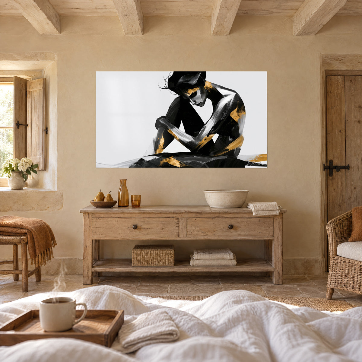 Wall art prostrate figure in black, silver and gold flat areas on a white background, a figure seen from behind above a bed in a light bedroom