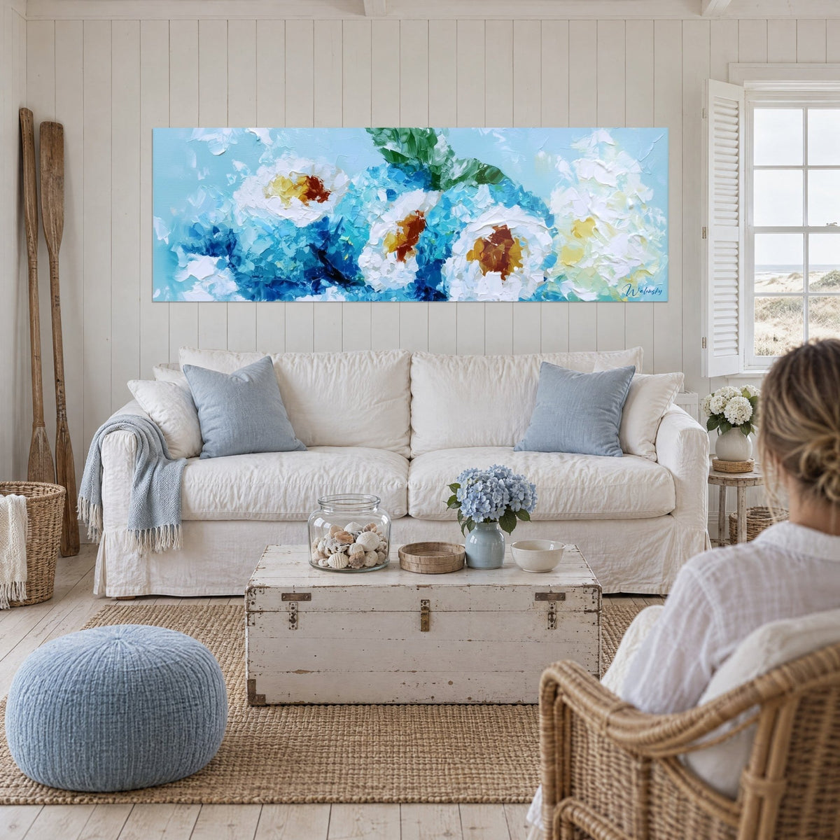 Wall art of sushi in cream white and turquoise blue relief, green mint leaf, above a sofa in a bright living room