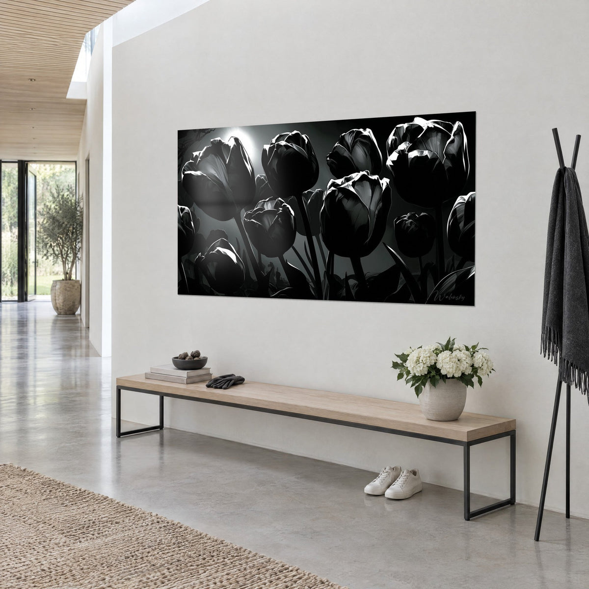 Wall art bouquet of dark blooms lit by a white halo, deep black and pearl grey, on a light wall above a bench