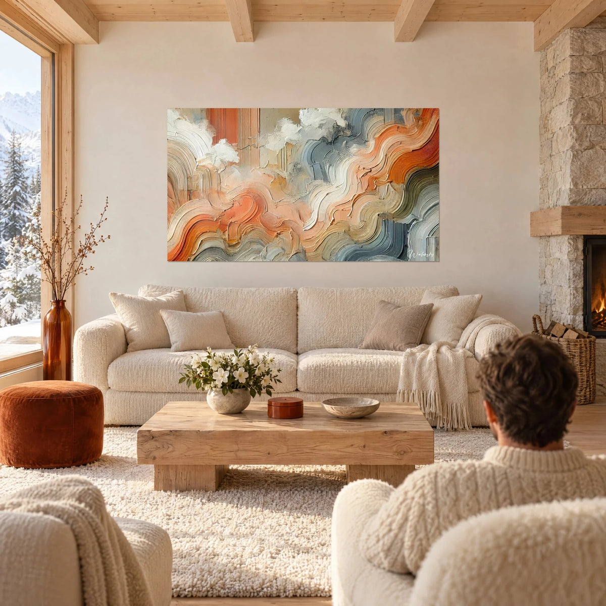 Wall art with orange clay ripples and slate blue in thick impasto strokes, two people seen from behind above a sofa in a bright living room
