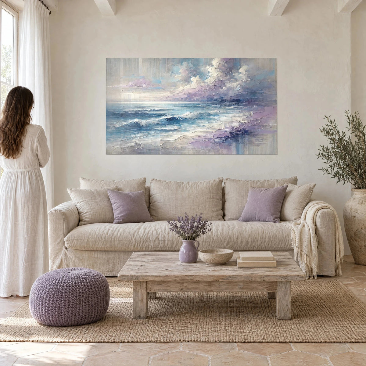 Wall art blue glacier swell under lilac clouds, thick palette-knife impasto, woman seen from behind, above a sofa in a bright living room