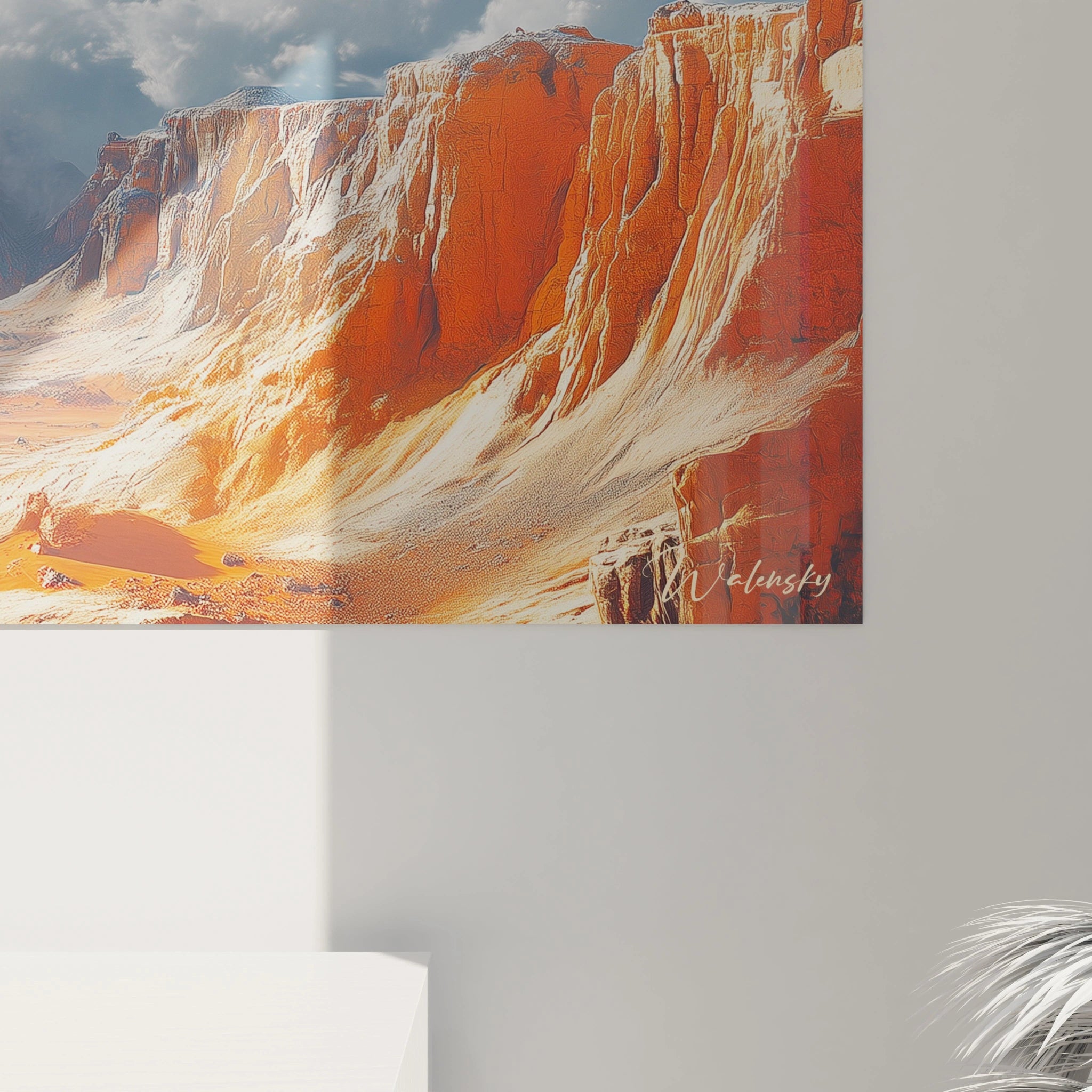 Un tableau montagne présentant un paysage désertique aux impressionnantes falaises stratifiées de couleur rougeâtre et ocre, dominant une plaine aride, avec un horizon lointain baigné de lumière sous un ciel bleu parsemé de nuages blancs cotonneux.