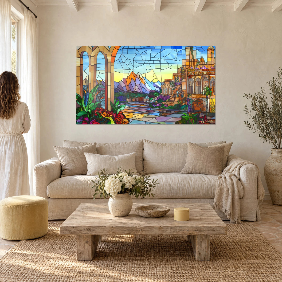Stained glass wall art of a violet and orange mountain under a yellow sky, ochre arcades, red flowers, above a sofa in a bright living room