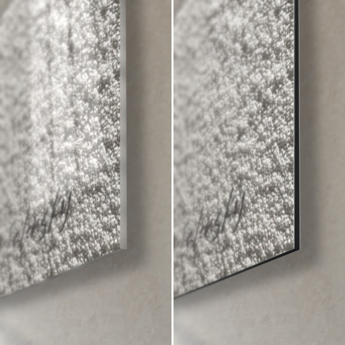 Wall art zen pebble on grainy white sand, bottom right corner: glossy acrylic glass with reflections on the left, matte black Dibond on the right, 3 mm edge