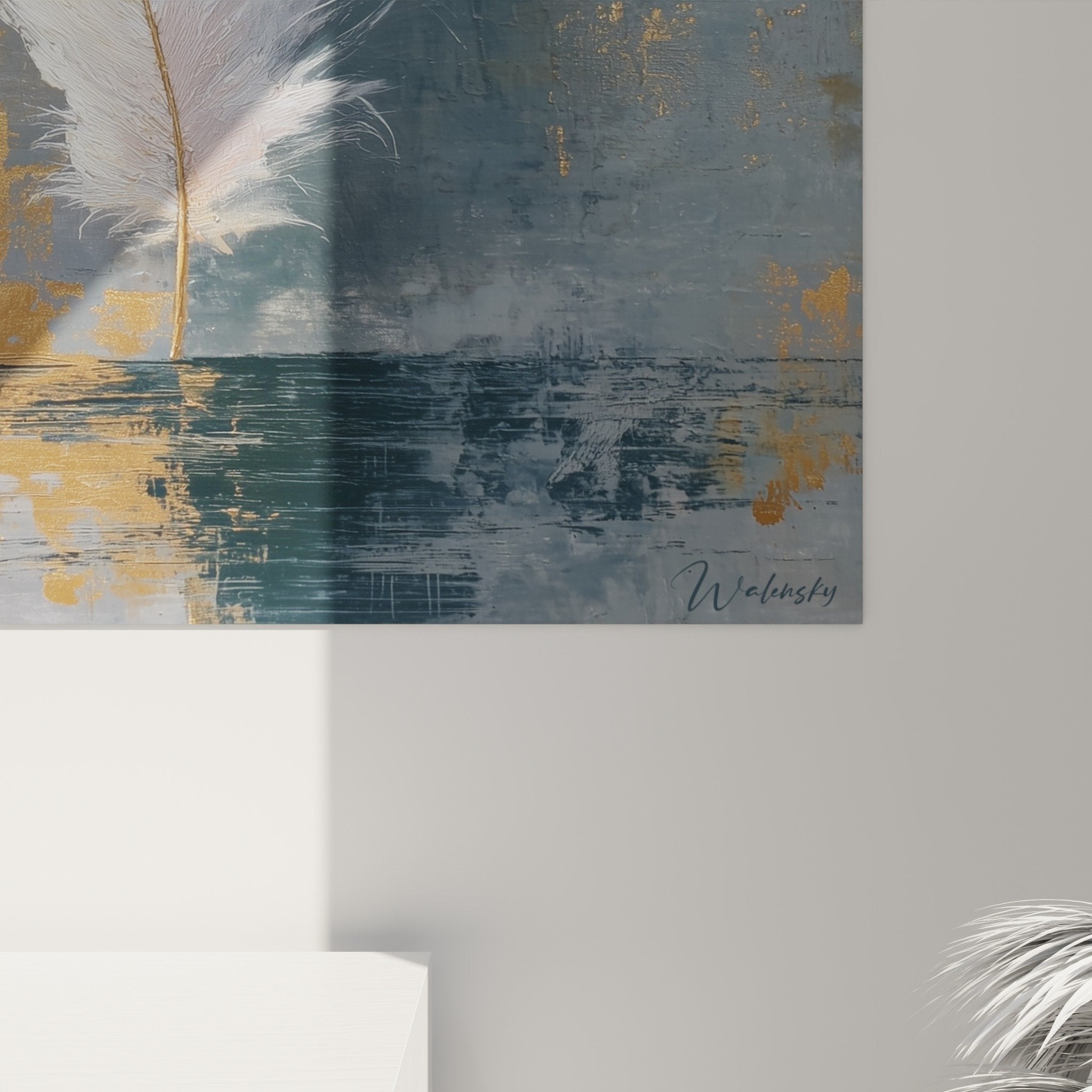 Overall view of white feather wall art on textured blue and grey background with luminous gold accents