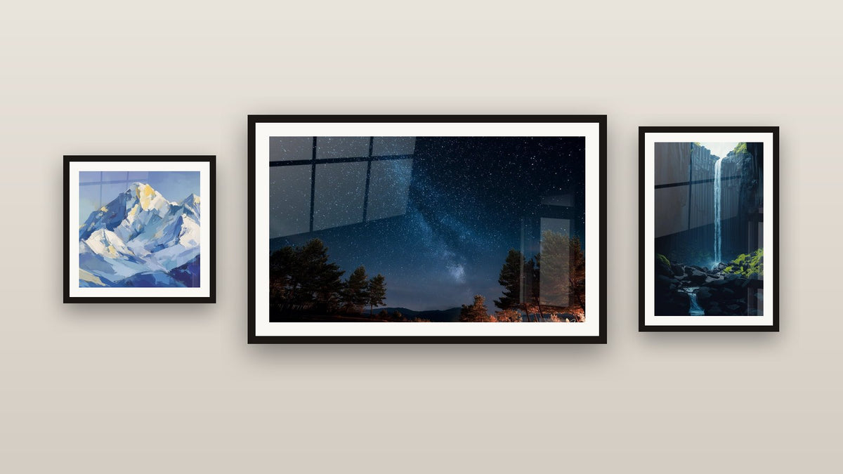 Gallery wall with three framed paintings, including Snowy Peak