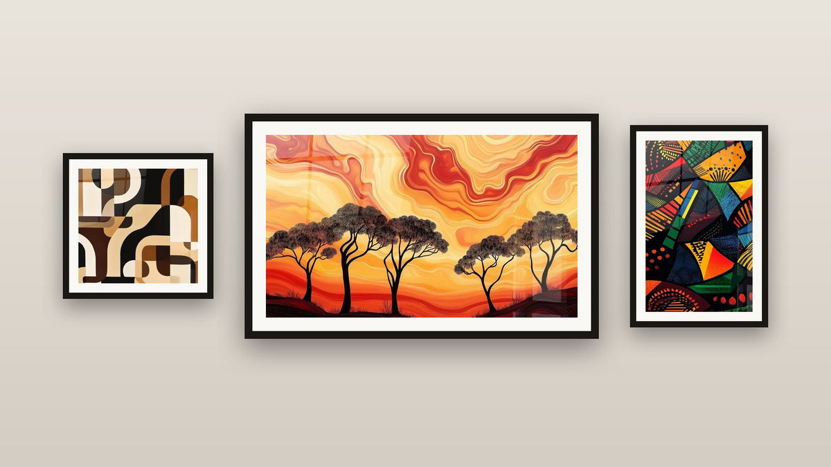 Gallery wall with three framed paintings, including African Lands Nomadic Dreams and African Forms Mosaic Sacred