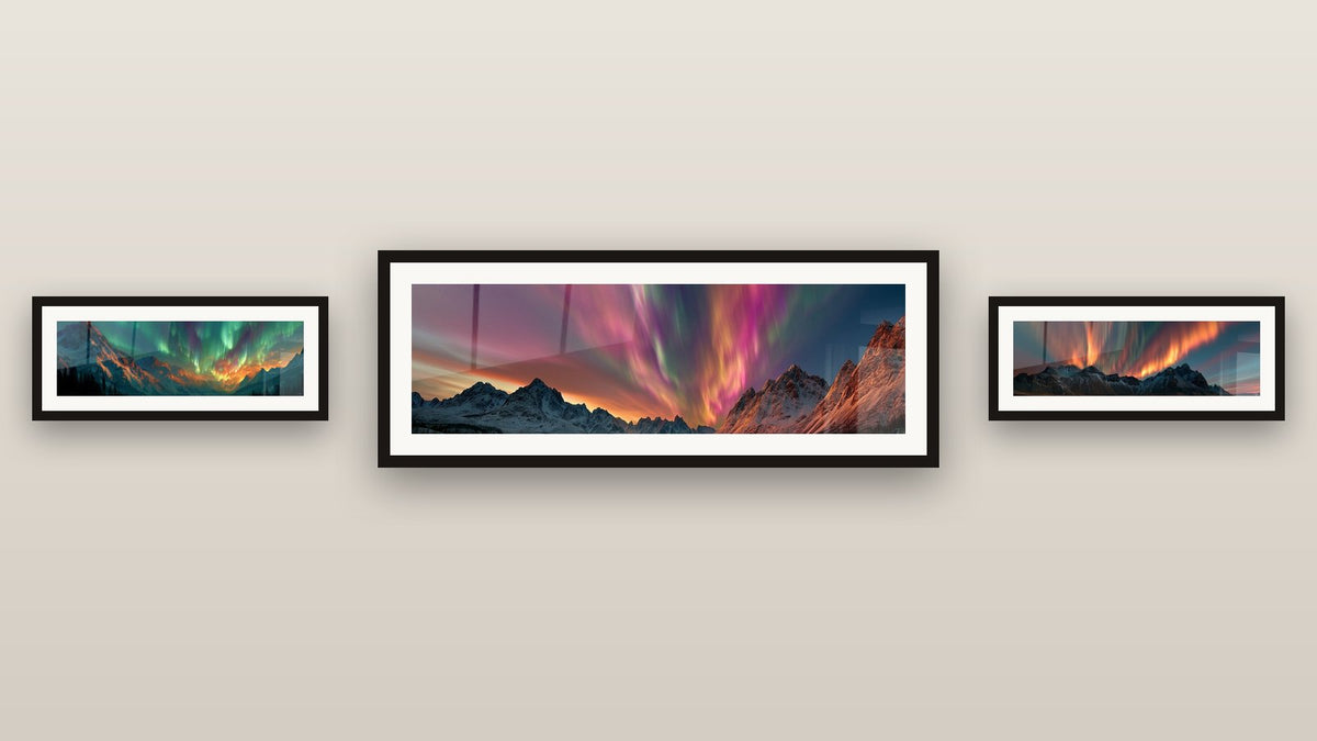Gallery wall with three framed paintings, including Snowy Mountains with Orange and Blue Glows