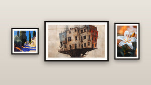 Gallery wall with three framed paintings: Mediterranean village, Suspended Building and Lily Wall Art N°2