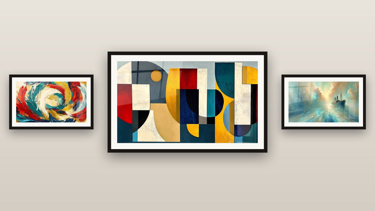 Gallery wall with three framed paintings: Colored geometric shapes, Cosmic Metamorphosis and Heart of the Breeze