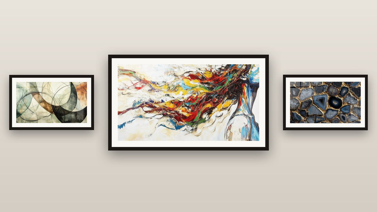 Gallery wall with three framed paintings, including Modern Muse and The Invisible Bonds