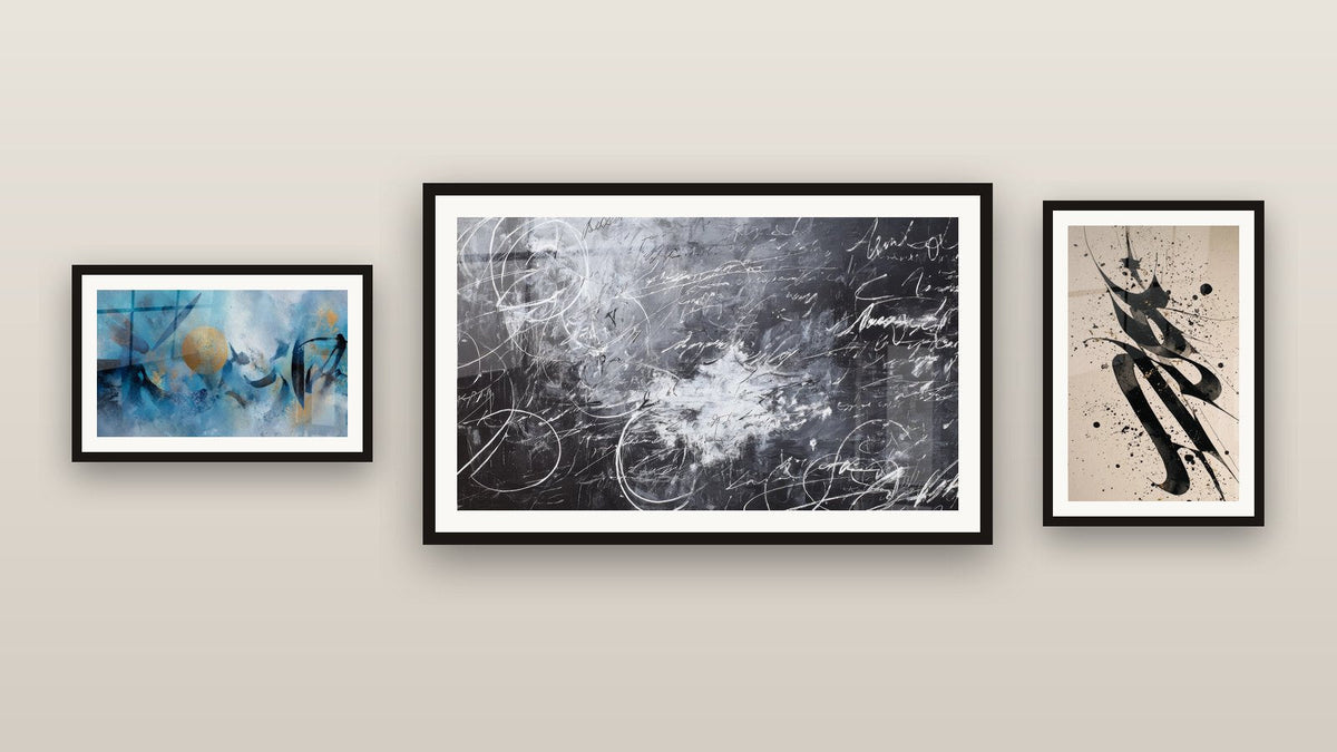 Gallery wall with three framed paintings, including Abstract Calligraphy and Abstract Golden Circle