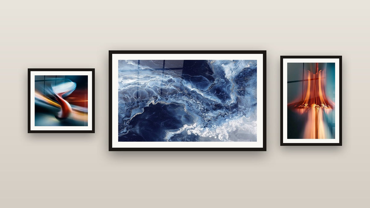Gallery wall with three framed paintings: Light Cascade, Modern Chair and Blue Nuances and Fluid Golden Veins