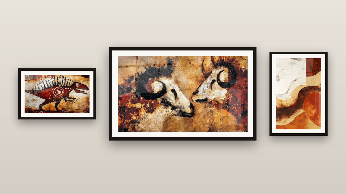 Gallery wall with three framed paintings, including Red Dinosaur and Primitive Bulls