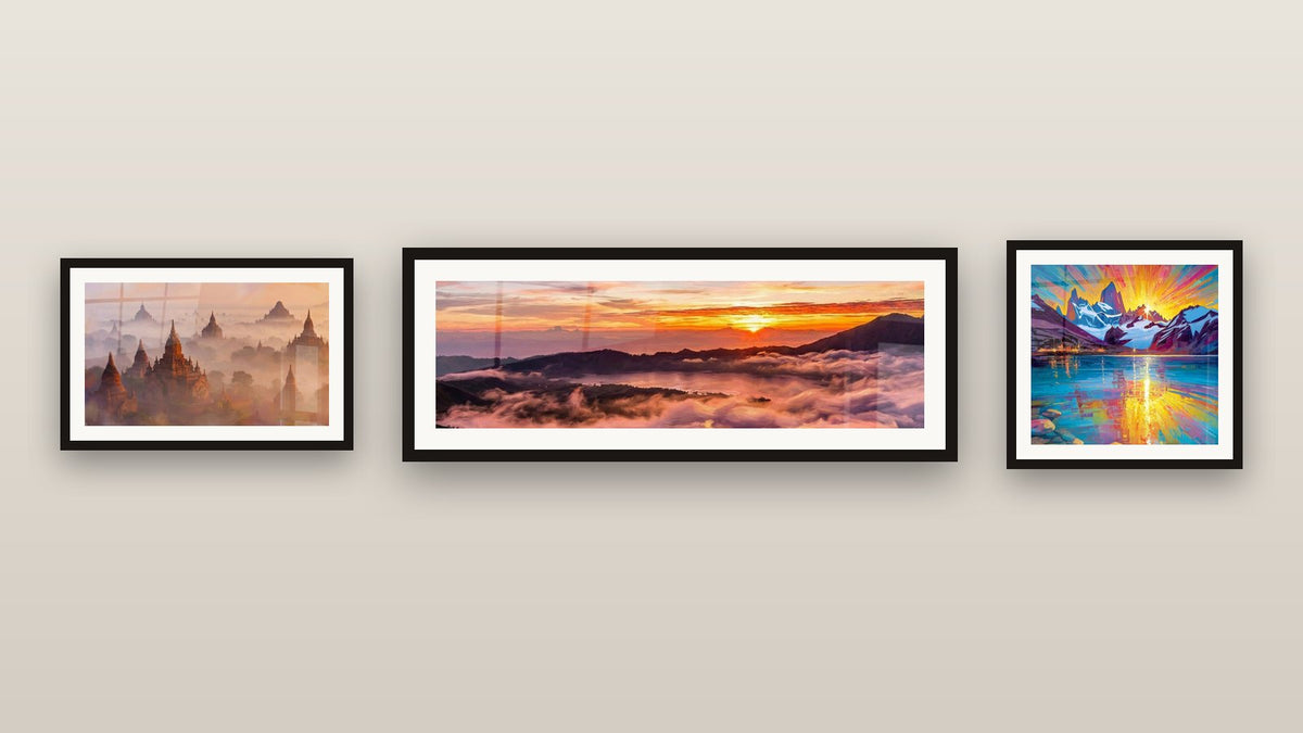 Gallery wall with three framed paintings, including Mountain Landscape Sunrise