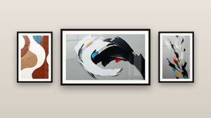 Gallery wall with three framed paintings: Dynamic Abstract, Abstract Feather and Organic Abstract Forms