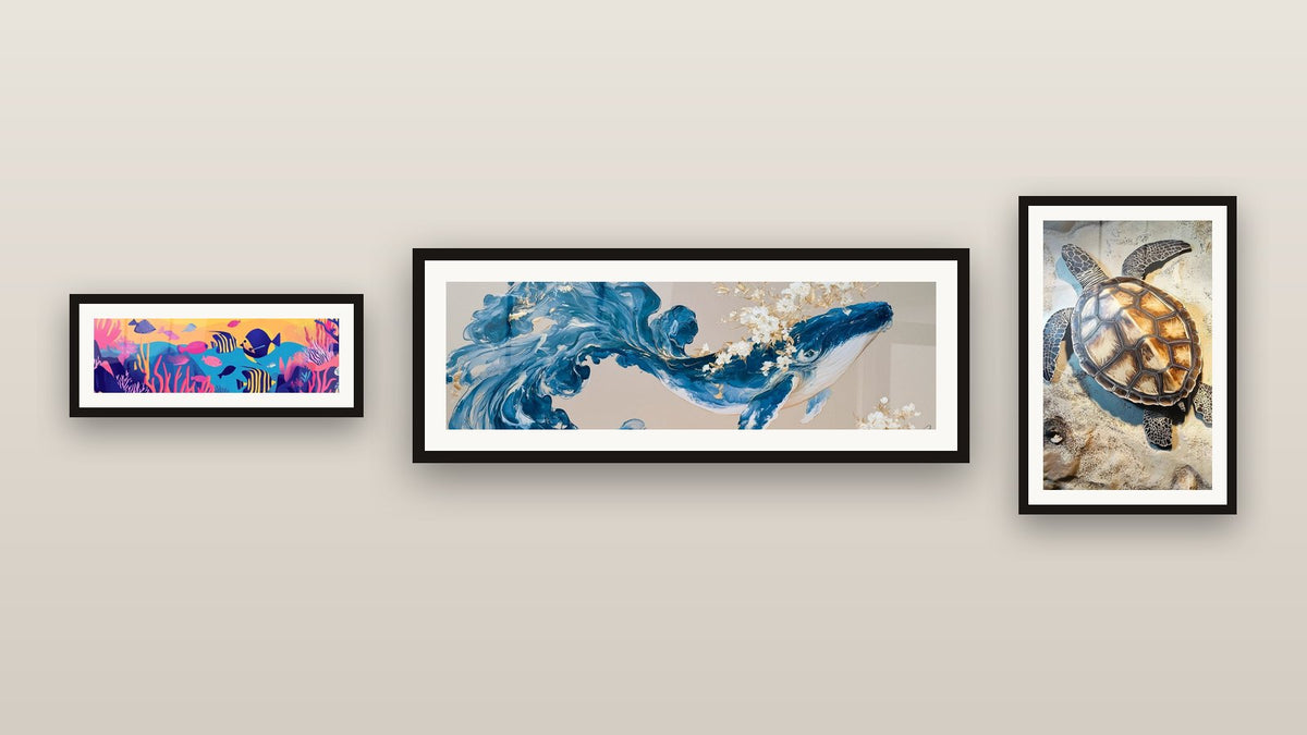 Gallery wall with three framed paintings, including Sea Turtle Suspended Time