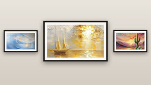 Mur de galerie avec trois tableaux encadrés : Onde cosmique bleue, Voilier coucher de soleil et Crépuscule du Désert