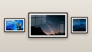Gallery wall with three framed paintings: Snowy Mountain, Milky Way Through Window and Cosmic Tree