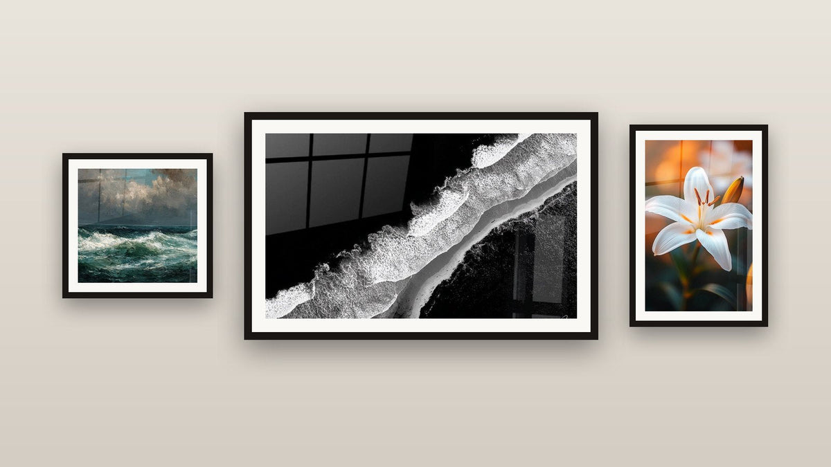 Gallery wall with three framed paintings: Aerial Beach View, Ocean Storm and Lily Wall Art N°2