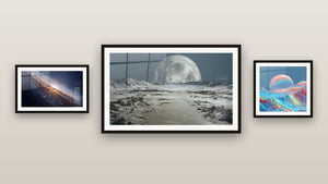 Gallery wall with three framed paintings: Andromeda Galaxy, Futuristic Lunar Landscape and Iridescent Moon Waves