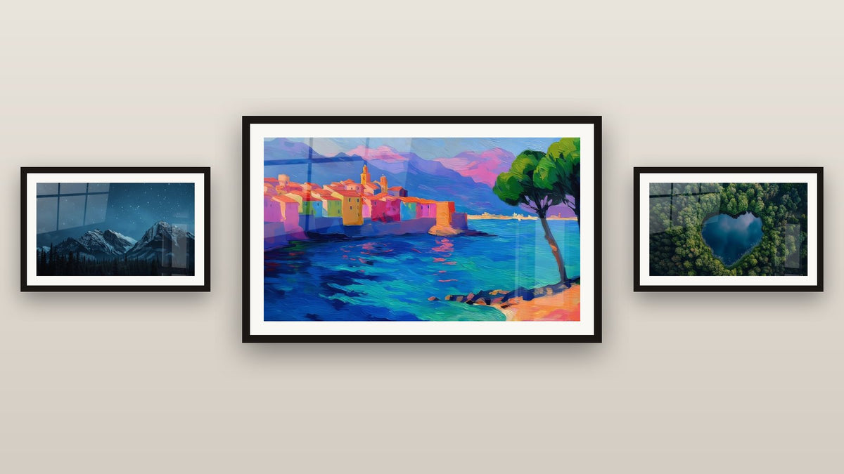 Gallery wall with three framed paintings, including Mediterranean Coastal Village and Snow-Covered Mountain