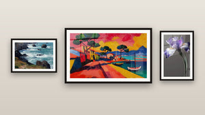 Gallery wall with three framed paintings: Colorful Coastal Village, Breton Rocky Coast and Iris Wall Art No. 9