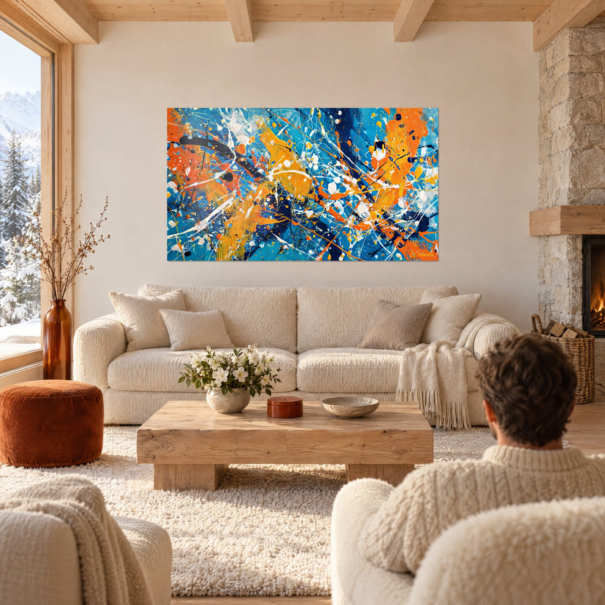 Tableau éclaboussures de peinture orange et bleu turquoise, gouttes blanches en filaments, au-dessus d'un canapé dans un salon lumineux