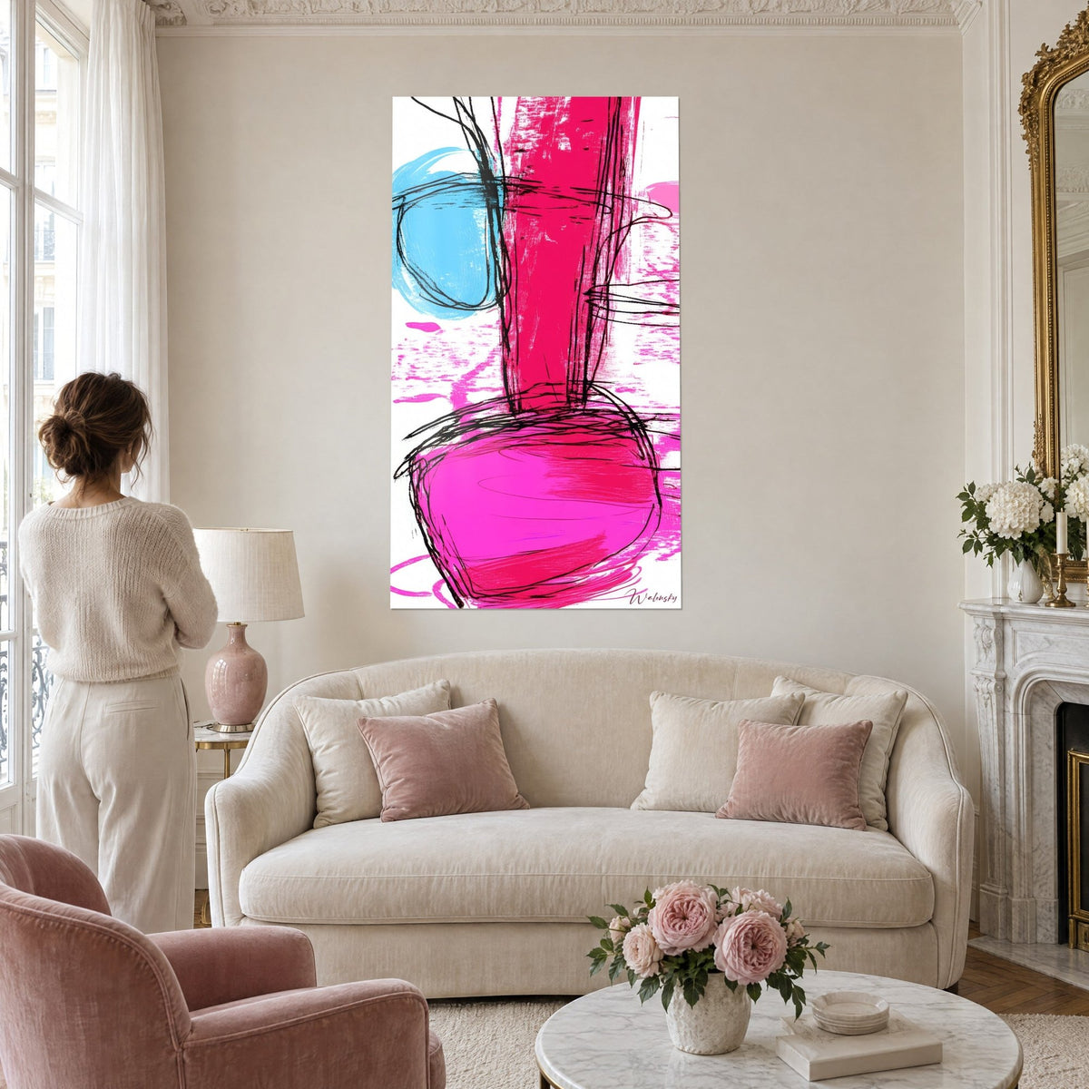 Wall art abstract with scribbled black lines, fuchsia stripe and azure disc, seen by a woman above a sofa in a bright living room