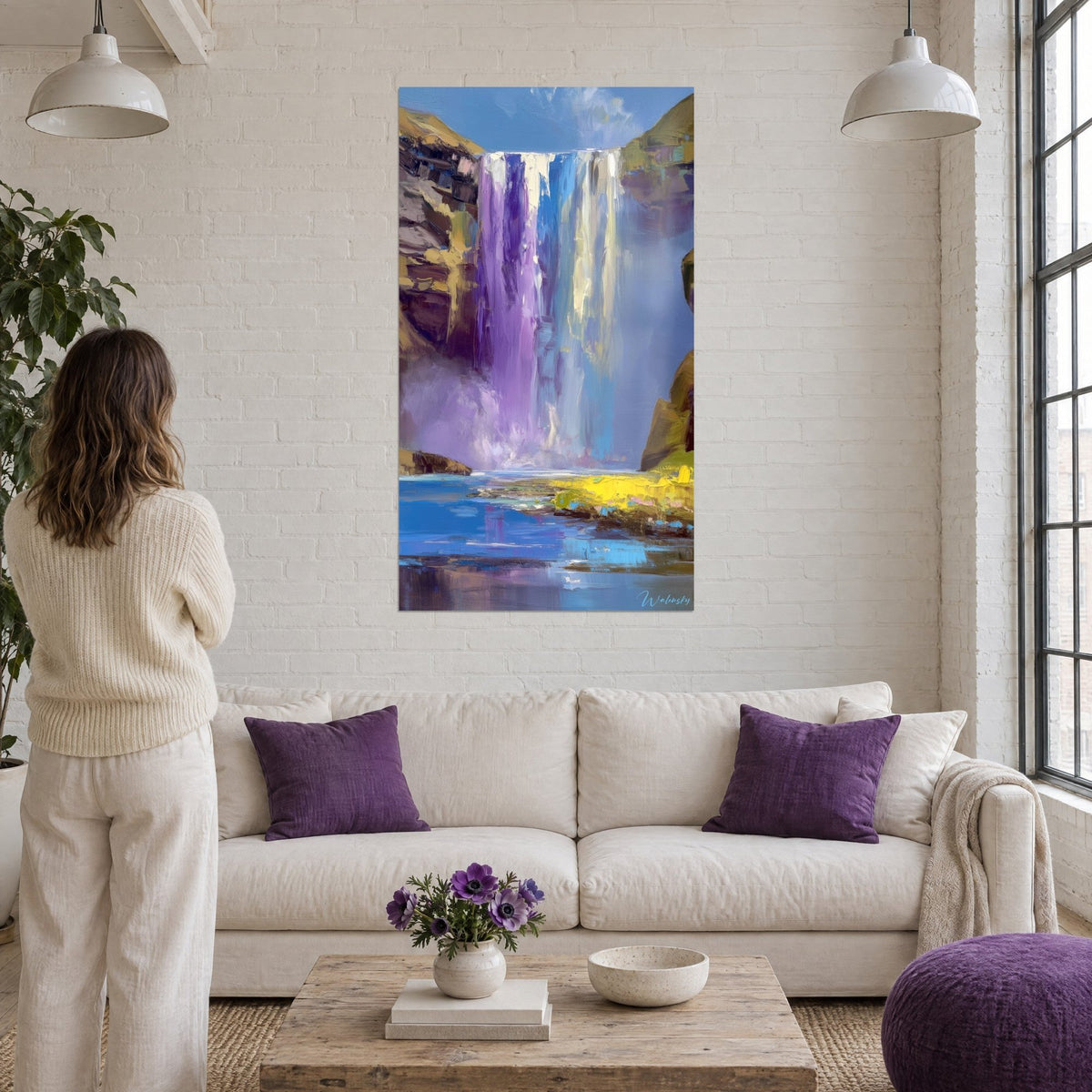Wall art waterfall with purple and blue streaks, ochre rocks and lilac mist, above a sofa in a bright living room