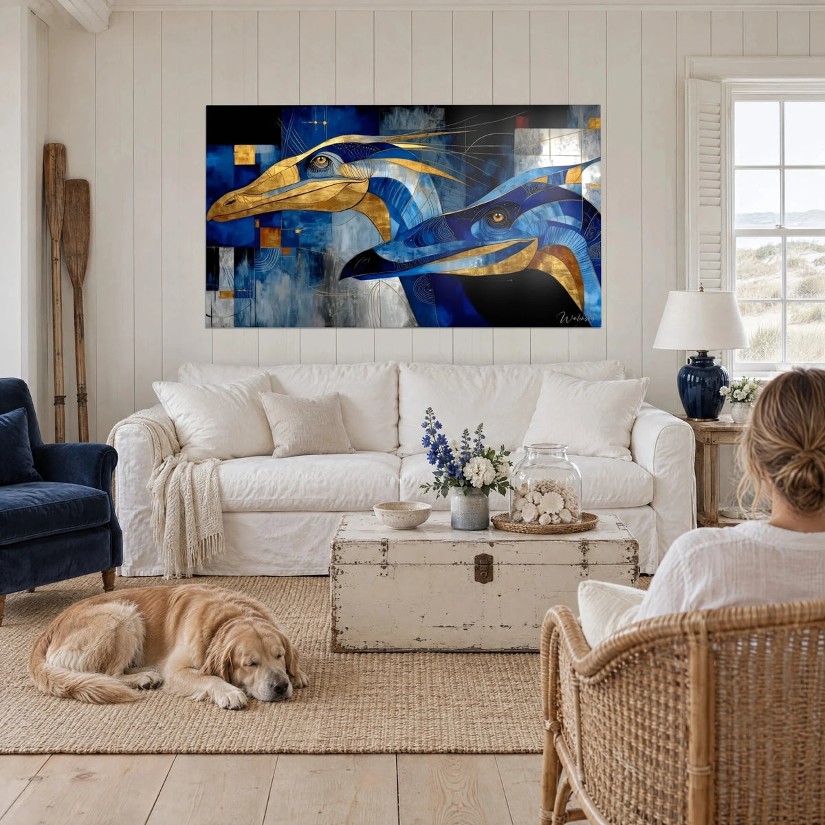 Wall art marine dinosaur with amber eyes, golden beak on cobalt blue background, reclining retriever, above a sofa in a bright living room
