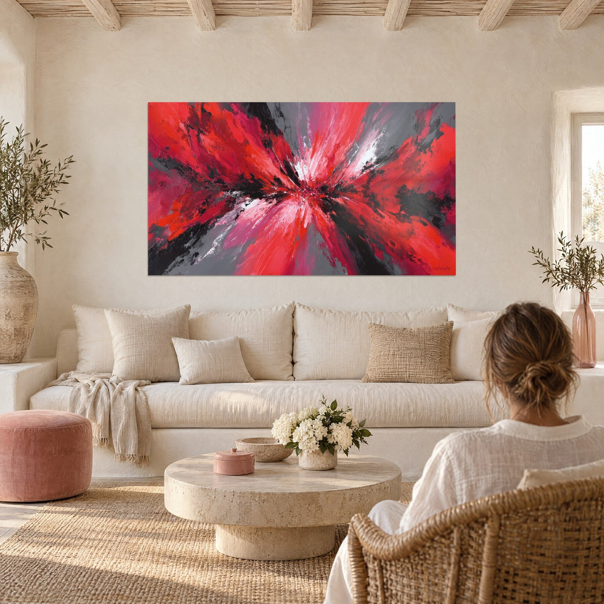 Wall art red and black abstract explosion, grey shards at the center, above a sofa in a bright living room