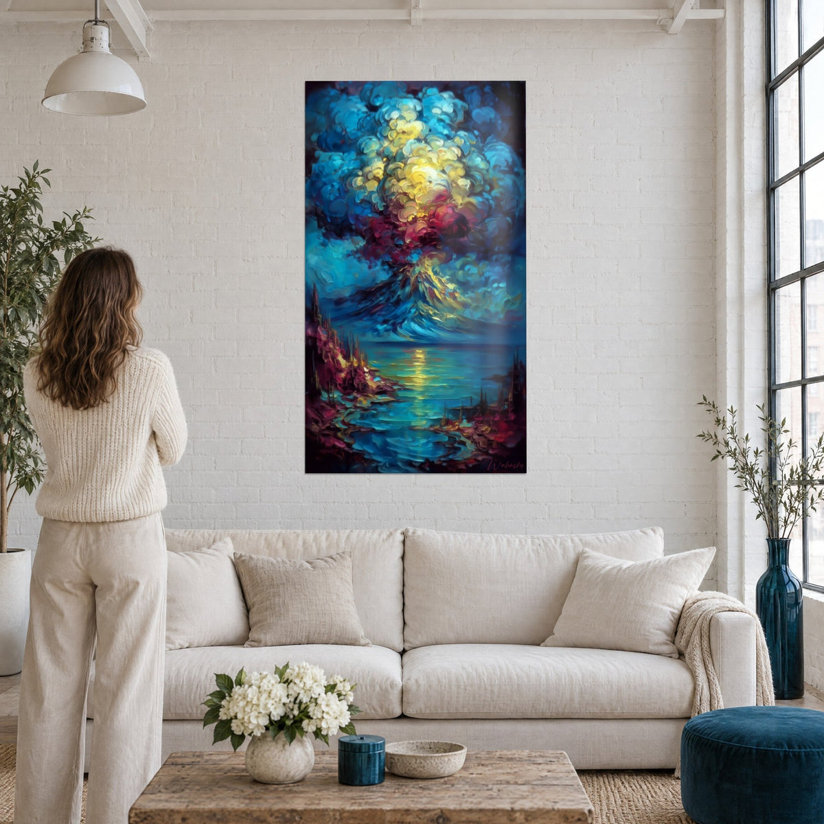 Wall art of an erupting volcano with lemon-yellow and carmine clouds, reflections on the sea, above a sofa in a bright living room
