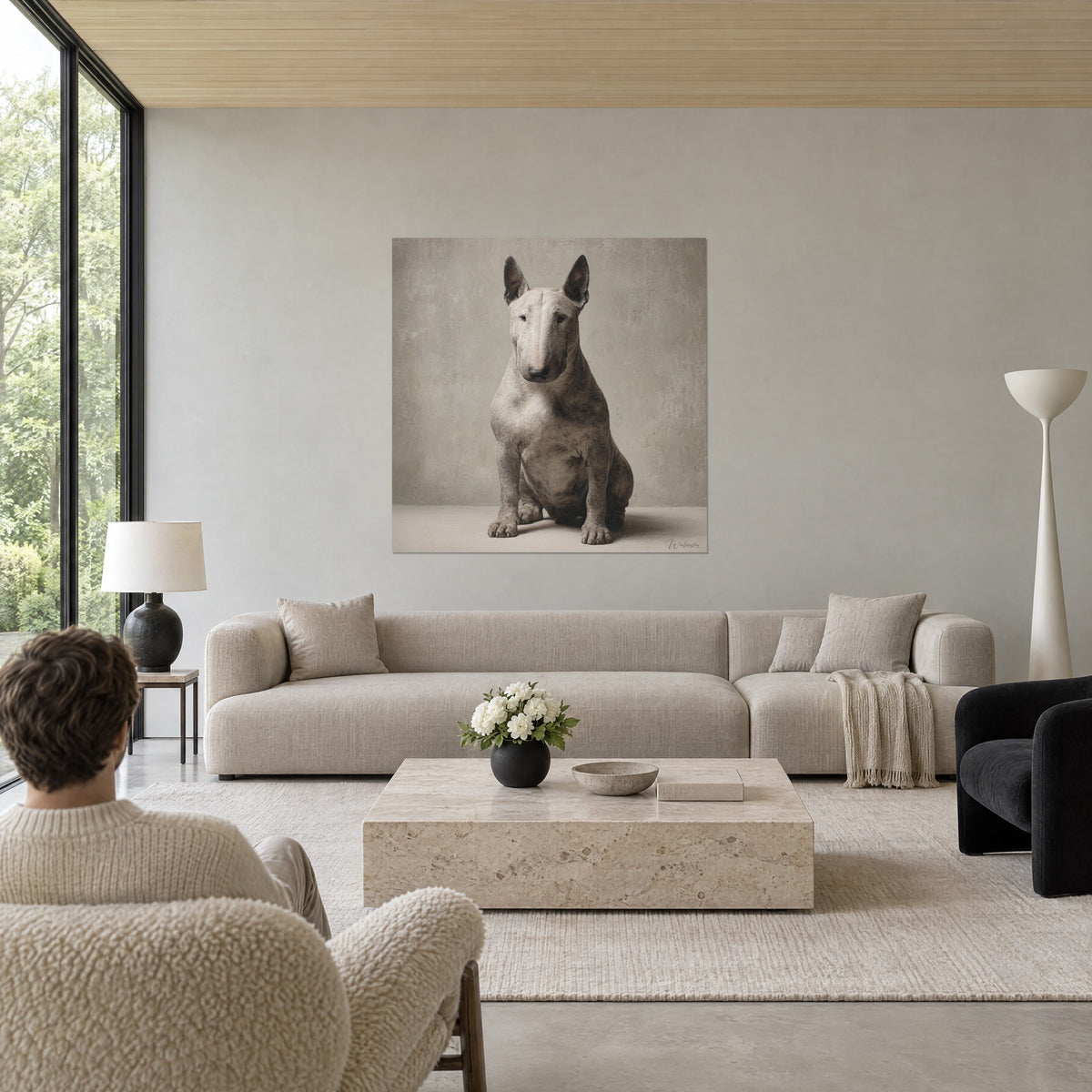 Obraz biały bull terrier siedzący ze stojącymi uszami, patynowane piaskowoszare tło, nad kanapą w jasnym salonie