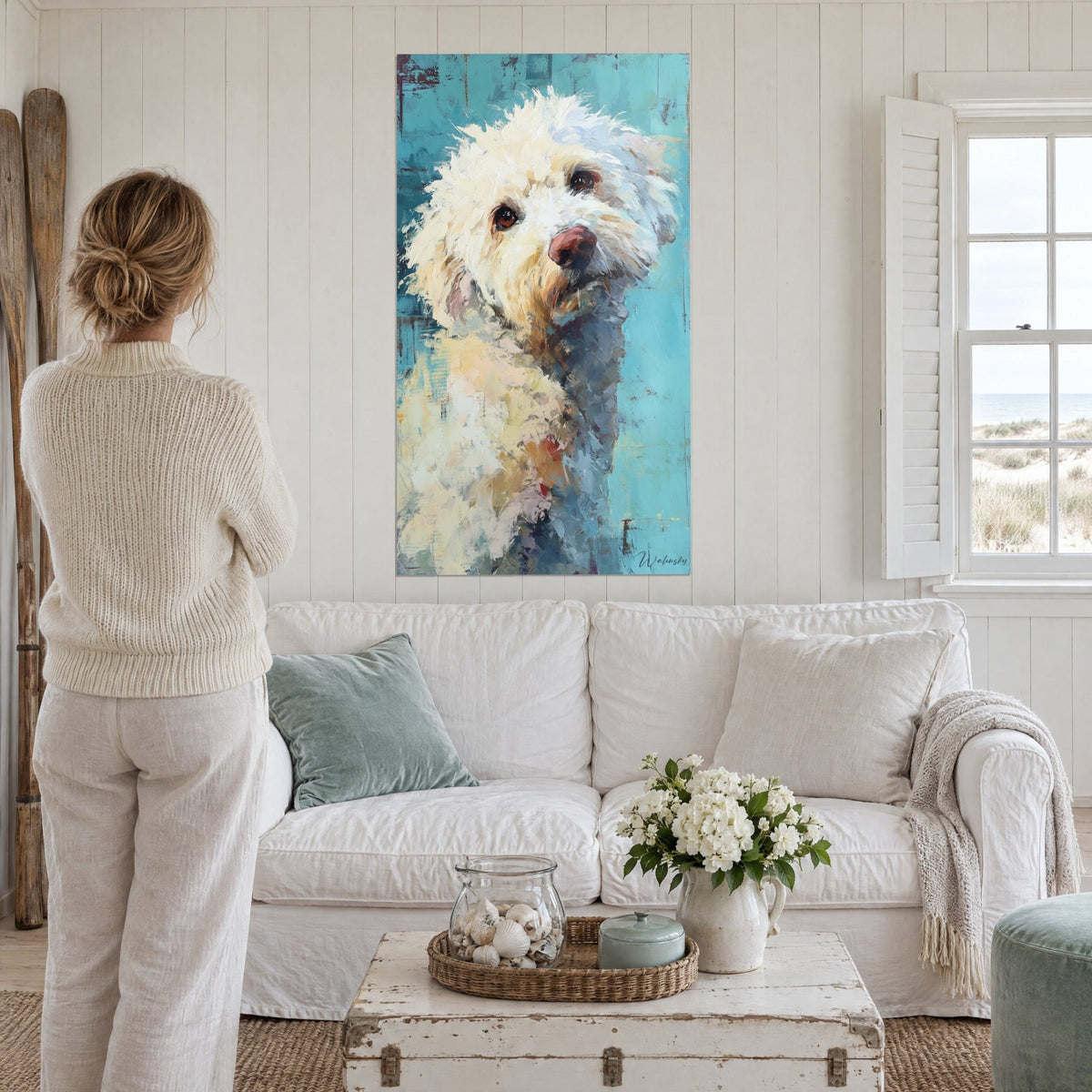 Wall art cream-white poodle with brown eyes, turquoise background, above a sofa in a bright living room