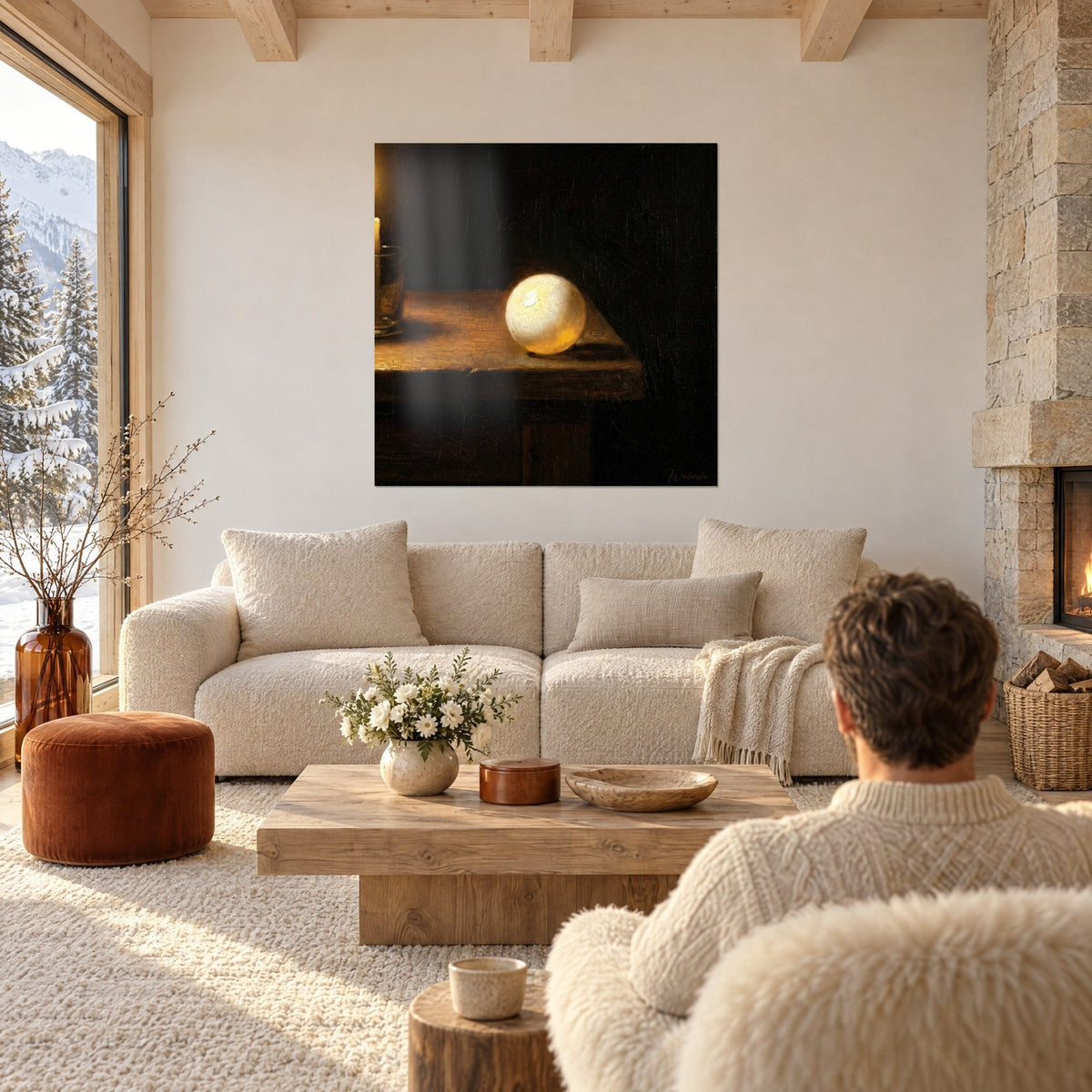 Wall art: glowing white ball on amber wooden table, black background, seen from behind above a sofa in a bright living room