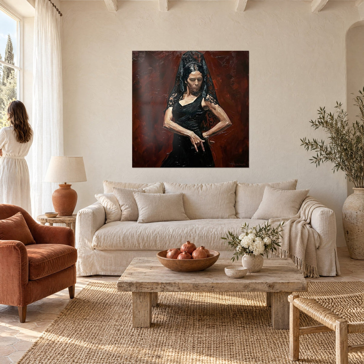 Wall art flamenco dancer in a black dress, lace mantilla and brick-red background, above a sofa in a bright living room