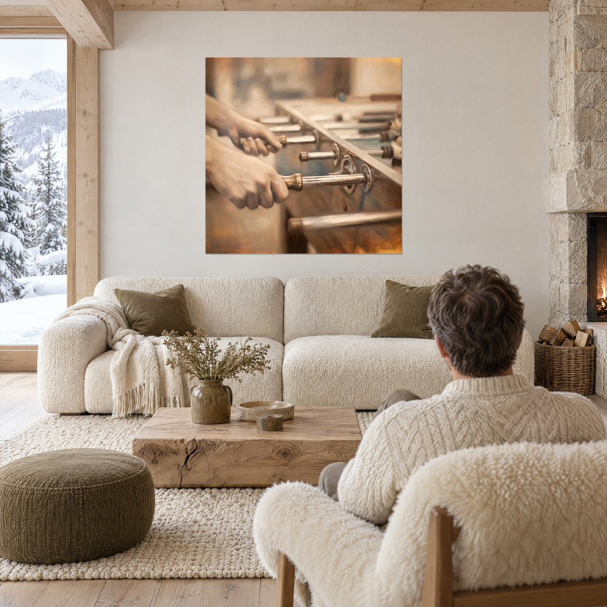 Schilderij handen die de handgrepen van een tafelvoetbal vasthouden, goudkleurig messing en gebruinde huid, een koppel van achteren, boven een bank in een lichte woonkamer