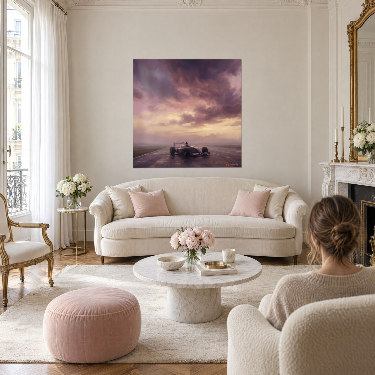 Wall art of a lone race car on a wet track, stormy mauve and ochre sky, hanging above a sofa in a bright living room