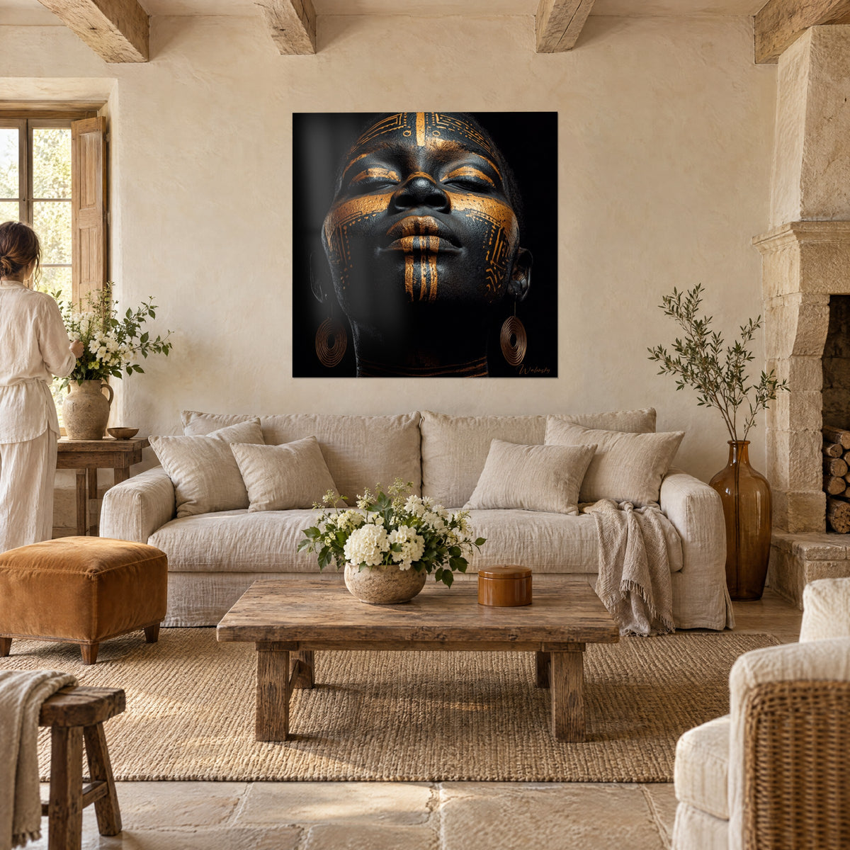 Tableau portrait africain aux motifs dorés sur peau noire, yeux clos, deux personnes de dos, au-dessus d'un canapé dans un salon lumineux