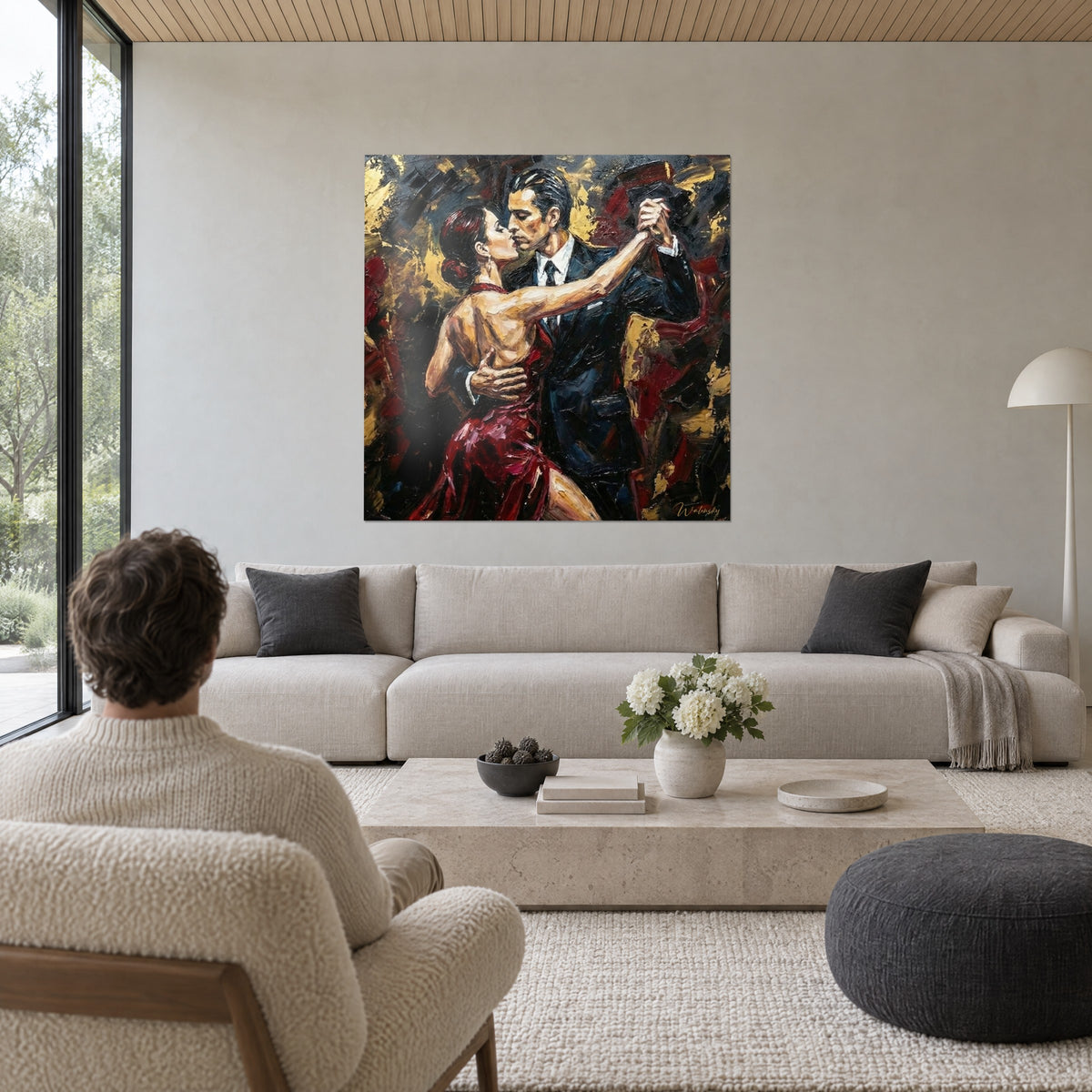 Wall art tango couple in an embrace, carmine red dress and black suit on a gold background, above a sofa in a bright living room